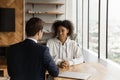 Rear view Caucasian hr manager interviewing confident African American woman Royalty Free Stock Photo