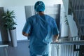 Male surgeon walking downstairs in hospital Royalty Free Stock Photo