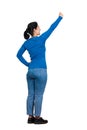 Rear view of cheerful brunette woman full length portrait raising arm as holding something imaginary, looking up confident. Brave