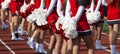 Rear view of cheerleaders holding pom poms behind them Royalty Free Stock Photo