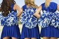 Rear View Of Cheerleaders With Pom Poms