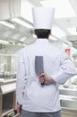 Rear View of Chef with Knife Behind his Back Royalty Free Stock Photo