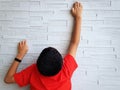 Rear View of Child Climbing up the Wall Royalty Free Stock Photo