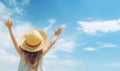 Relaxed girl breathing fresh air raising arms over blue sky at summer. Royalty Free Stock Photo