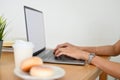 Rear view, closeup shot of a businesswoman or female working, using notebook laptop Royalty Free Stock Photo