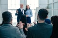 Rear view. company employees applauding at a work meeting