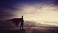 Rear view confident businessman, red cape suit, as hero stands on the rooftop of a skyscraper looking over the city horizon. Royalty Free Stock Photo