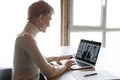 Rear view confident businesswoman talking on video call with colleague Royalty Free Stock Photo