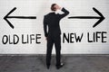 Confused Businessman Looking At Old And New Life On Wall Royalty Free Stock Photo