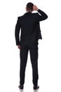 Rear view of a confused businessman scratching his head Royalty Free Stock Photo