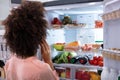 Woman Searching For Food In Refrigerator Royalty Free Stock Photo