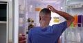 Rear view of a confused young man looking at food Royalty Free Stock Photo