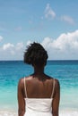 Woman by the sea: Contemplation and serenity at the tropical beach Royalty Free Stock Photo