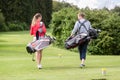 Rear view of couple carrying golf bag Royalty Free Stock Photo