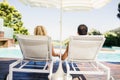Rear view of couple on deck chairs Royalty Free Stock Photo