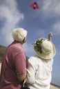 Rear View Of A Couple Flying Kite