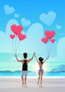 Rear view couple holding pink heart shape air balloons sea ocean beach summer vacation concept african american man