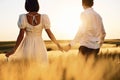 Rear view. Couple just married. Together on the majestic agricultural field at sunny day Royalty Free Stock Photo