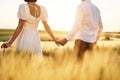 Rear view. Couple just married. Together on the majestic agricultural field at sunny day Royalty Free Stock Photo