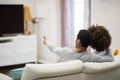 Rear View Of Couple Sitting On Sofa Watching TV Together Royalty Free Stock Photo