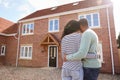 Rear View Of Couple Standing Outside New Home On Moving Day Looking At House Royalty Free Stock Photo