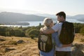 Rear View Of Couple Standing At Top Of Hill On Hike Through Countryside In Lake District UK Royalty Free Stock Photo