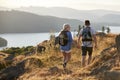 Rear View Of Couple Walking On Top Of Hill On Hike Through Countryside In Lake District UK Royalty Free Stock Photo