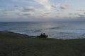 Couple watching ocean sunset Royalty Free Stock Photo