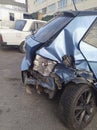 Rear view of a crashed blue hatchback car at street Royalty Free Stock Photo