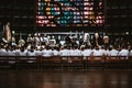 Mass in a Cathedral with many novices on the wooden benches