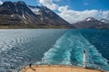 Rear view from a cruise ship on a fjord near Seydisfjordur, iceland, mountain range in the background Royalty Free Stock Photo