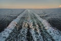 Rear view from cruise ship over the empty sea with trail of waves and white foam