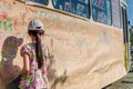 Rear view of cute little girl drawing a picture on the wall Royalty Free Stock Photo