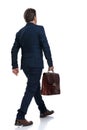 Rear view of a determined businessman walking