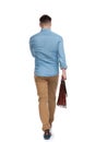 Rear view of a determined casual man holding briefcase Royalty Free Stock Photo