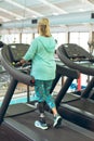 Disabled active senior woman exercising on treadmill in fitness studio Royalty Free Stock Photo