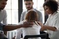 Rear view diverse people supporting upset woman at therapy session Royalty Free Stock Photo