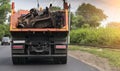 Rear view of a dump truck loaded on the road laden with scrap metal Royalty Free Stock Photo