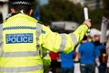 Large Metropolitan Police sign on the high visibility worn by an officer.