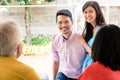 Rear view of elderly couple visited by their son or daughter