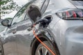 Rear view of electric e-car on charge using granny cable charging from home 13amp charge point Royalty Free Stock Photo