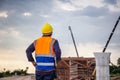 Rear view of Engineer under inspection and checking project at the building site, Foreman worker in hardhat at the infrastructure Royalty Free Stock Photo