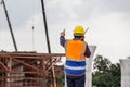 Rear view of Engineer under inspection and checking project at the building site, Foreman worker in hardhat at the infrastructure Royalty Free Stock Photo