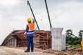 Rear view of Engineer under inspection and checking project at the building site, Foreman worker in hardhat at the infrastructure Royalty Free Stock Photo