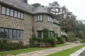 The rear view of an English country house in Devon, England. The building has an interesting circular turret Royalty Free Stock Photo