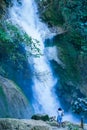 European woman taking pictures of Kuang Si Falls