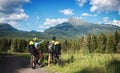 Rear view of family with small children cycling outdoors in summer nature. Royalty Free Stock Photo