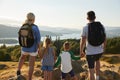 Rear View Of Family Standing At Top Of Hill On Hike Through Countryside In Lake District UK Royalty Free Stock Photo