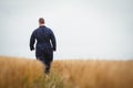 Rear view of farmer walking in the field Royalty Free Stock Photo