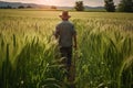 Rear view of farmer walking in a green wheat field. Generative AI Royalty Free Stock Photo